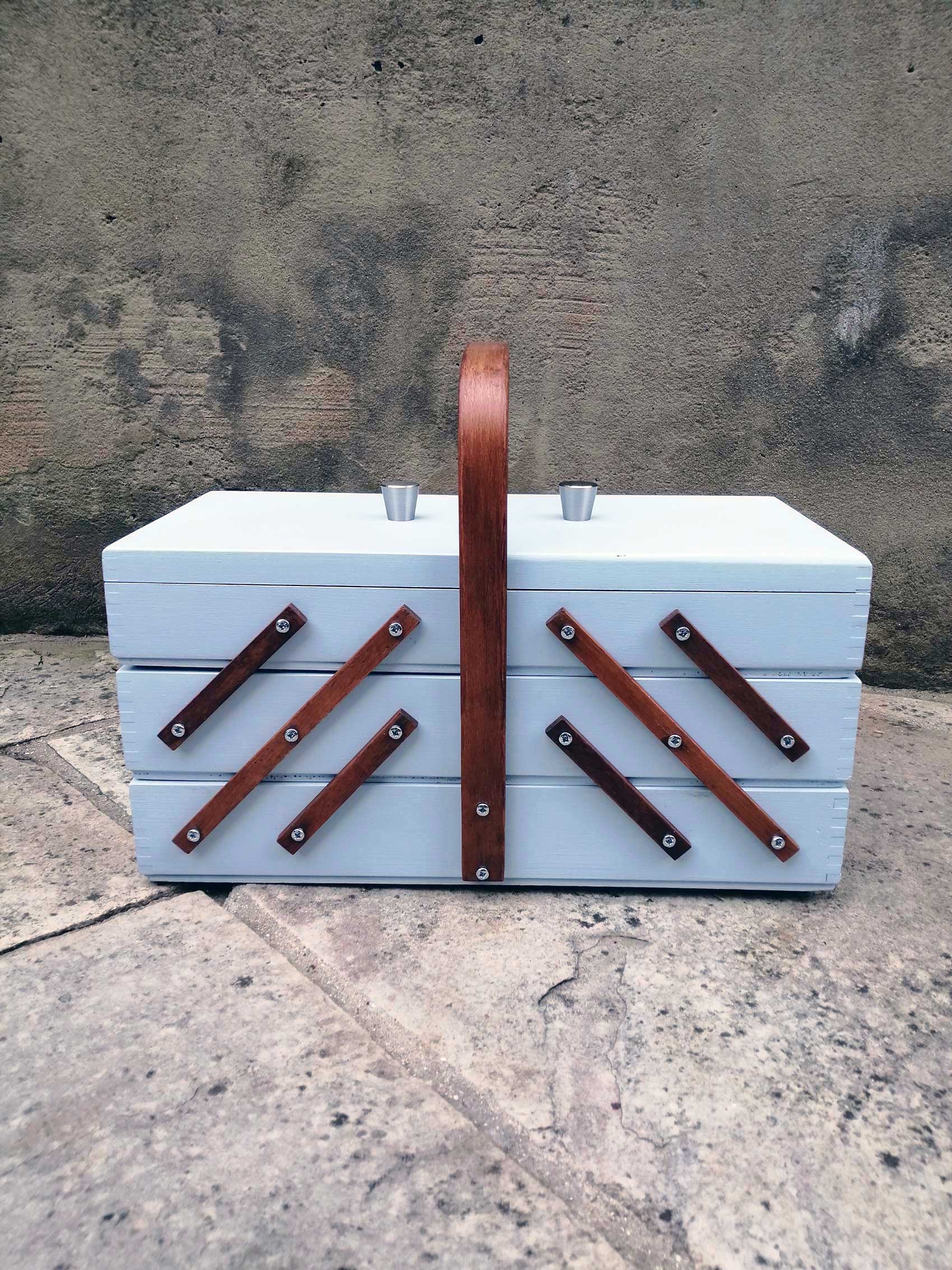 Antique wooden sewing box on legs. Storage box for sewing supplies